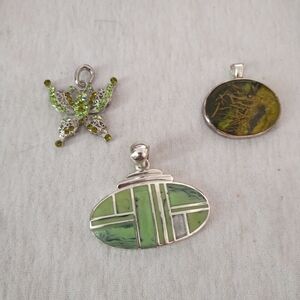 3 silver toned pendants